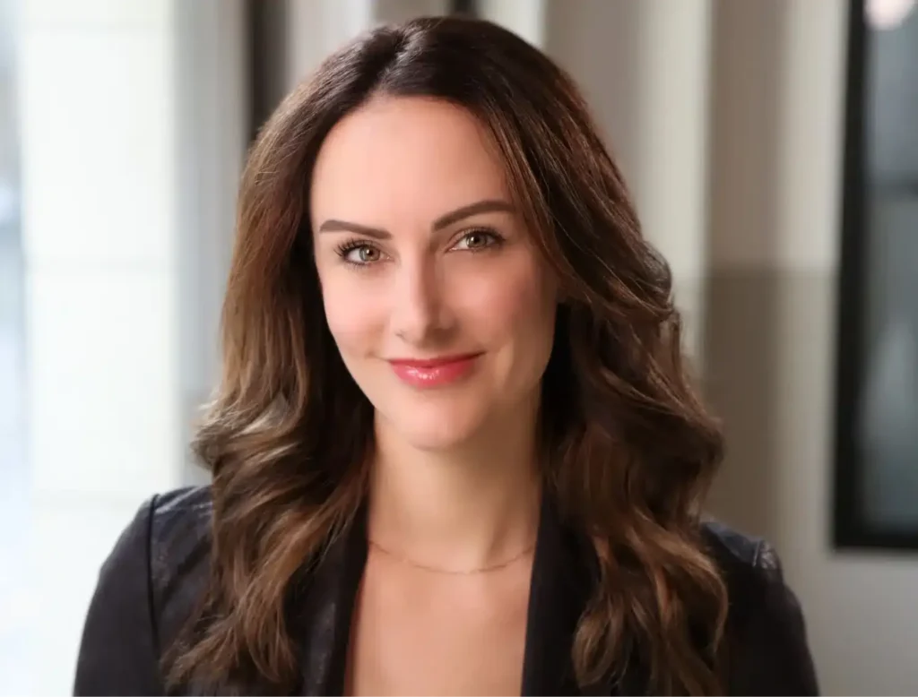 Brunette woman posing for professional female corporate headshots in a modern NYC studio.
