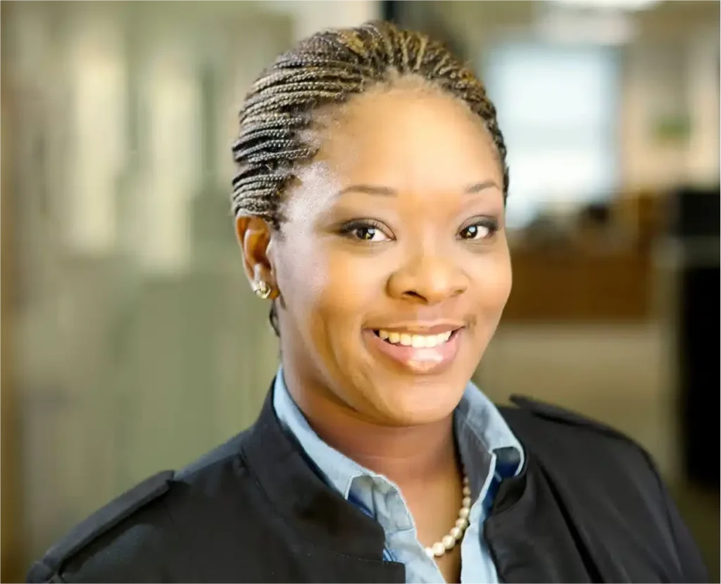 Confident female financial professional smiling for corporate headshots NYC in a Wall Street office setting.